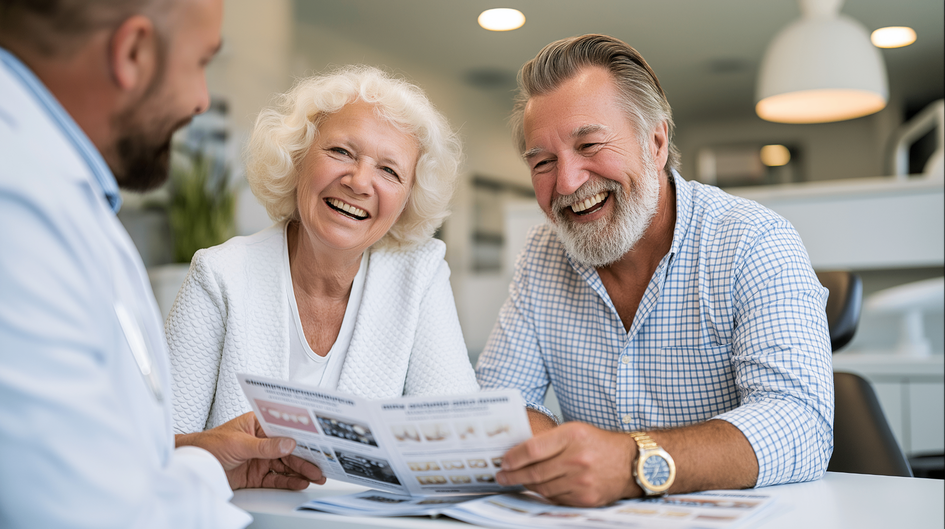 Older patient and dentist reviewing tooth replacement options together across a consultation table