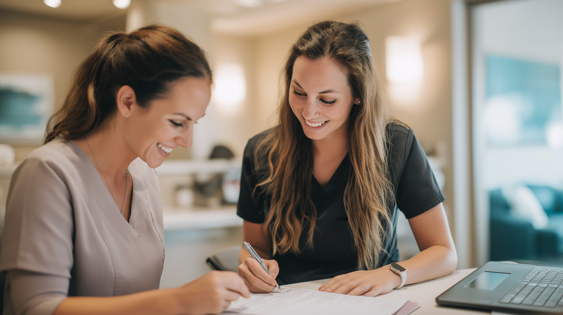 All-on-4 dental implant cost consultation between a treatment coordinator and patient reviewing a pricing estimate